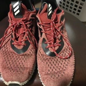 Pair of red adidas alpha bounce